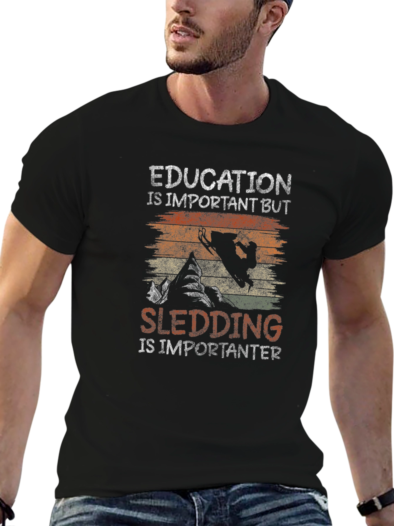Education Vs Sledding Graphic Tee
