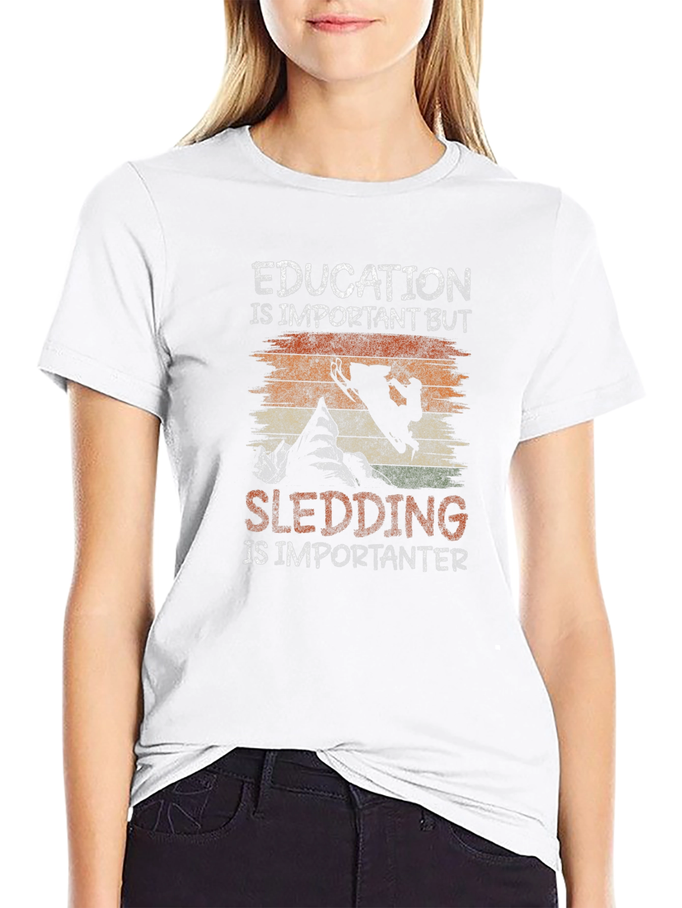 Education Vs Sledding Graphic Tee